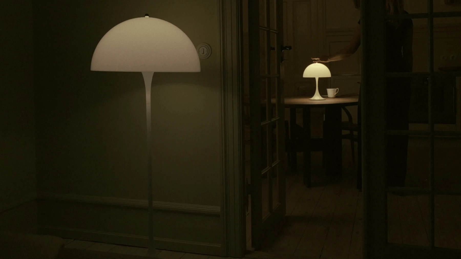Two Opal Panthella lamps in a dark setting with soft ambient light, © 2025 Louis Poulsen