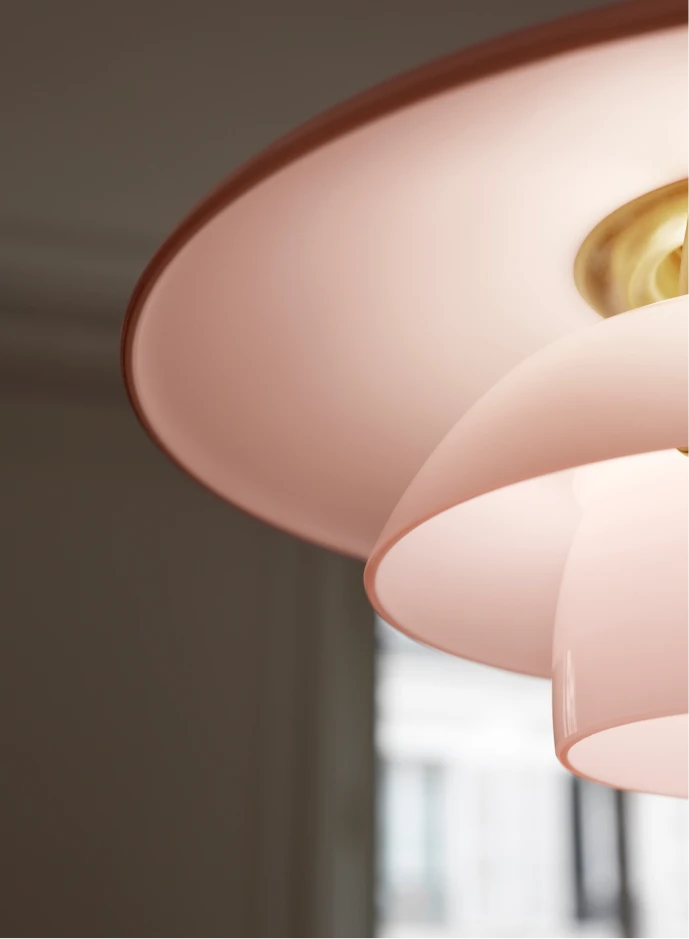 Close-up of the PH 3½-3 Pale Rose Brass Pendant, showing its pale rose shades and brass detail. © 2026 Louis Poulsen.