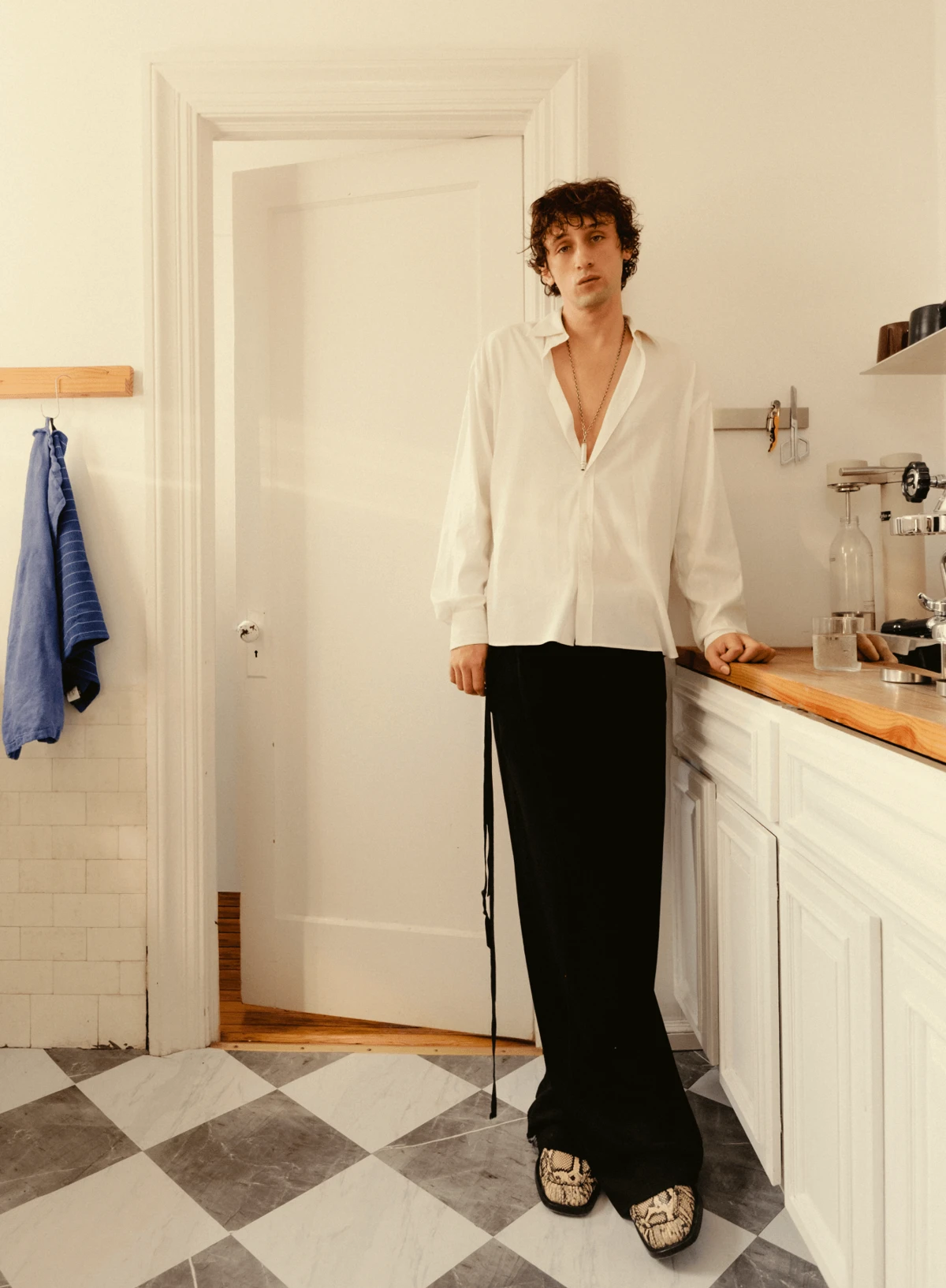 Eric Jess in bright minimalist kitchen, part of FJ Elements campaign, © 2025 Louis Poulsen.