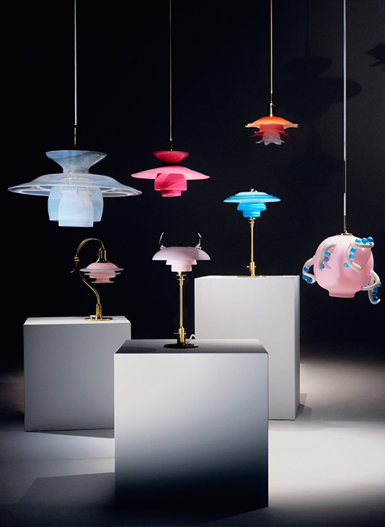 Colourful glass PH 5 pendants and table lamps are displayed on plinths against a dark backdrop. © 2026 Louis Poulsen.