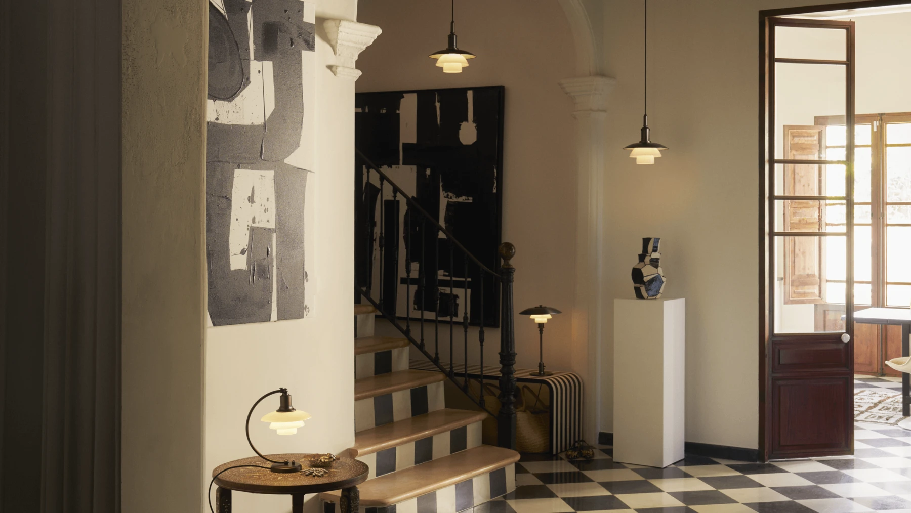 PH Aged Brass Opal pendant lamp illuminating the staircase in a modern interior, © 2025 Louis Poulsen
