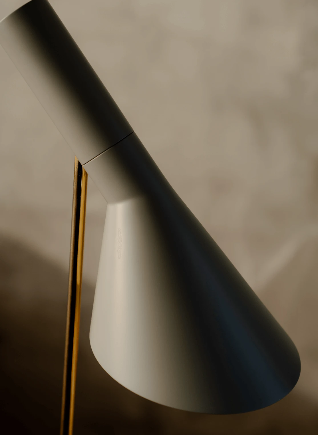 Detail of AJ Floor lamp with brass stem and matte grey shade, © 2025 Louis Poulsen.