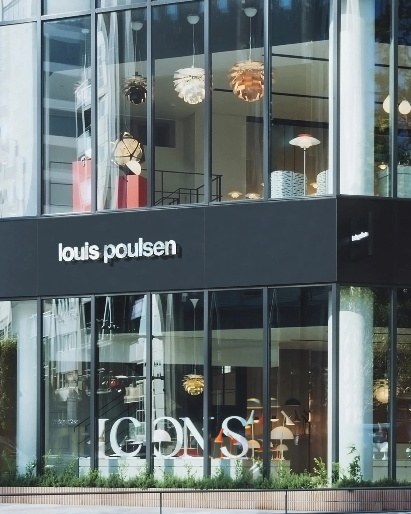 PH Artichoke pendants are visible through the glass facade of the Louis Poulsen store in Tokyo. © 2026 Louis Poulsen.