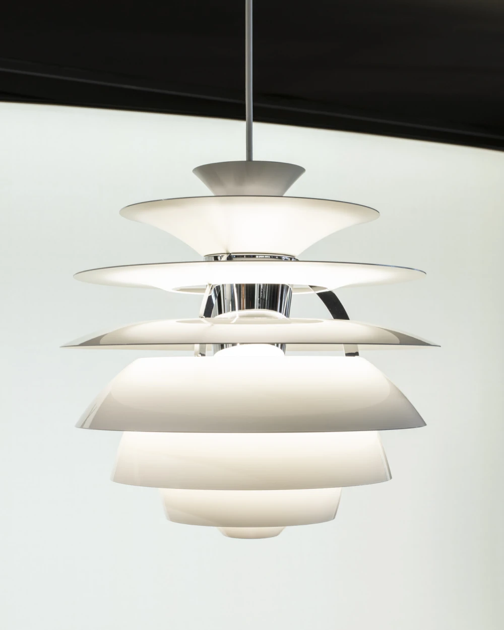 A white PH Snowball pendant glows against a pale background. © 2026 Louis Poulsen.