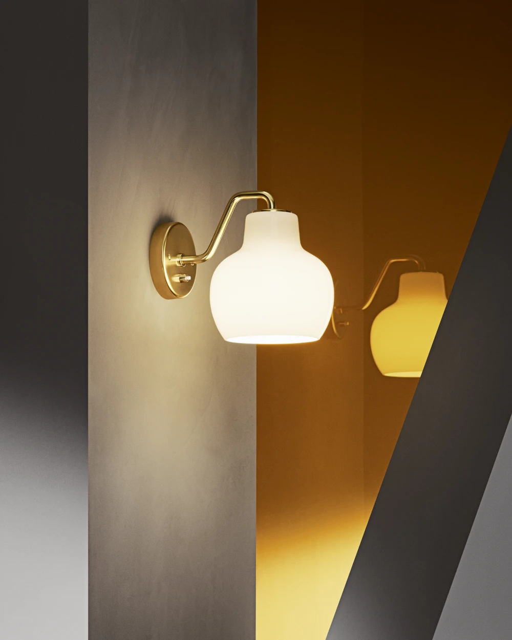 A VL Ring Crown 1 Wall Lamp with opal glass and a brass finish casts a warm glow on a textured wall. © 2026 Louis Poulsen.