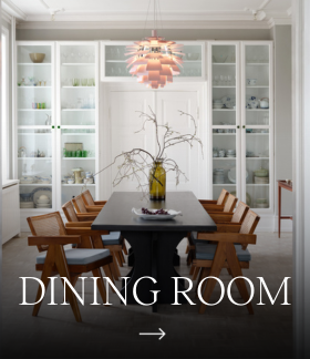 A copper-toned PH Artichoke pendant hangs above the dining table in a bright room with built-in cabinets. © 2026 Louis Poulsen.
