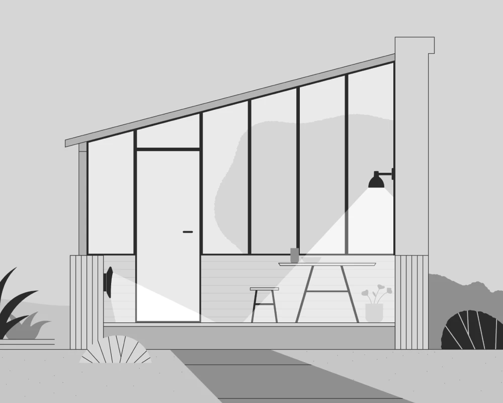 Toldbod 155 Outdoor Wall Lamps flank a glass-walled orangery with a small patio table and chairs. © 2026 Louis Poulsen.