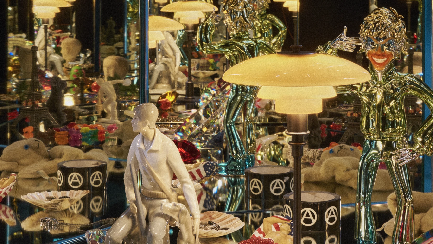 A PH 2/1 Dusty Terracotta Table Lamp glows warmly among mirrors, figurines and colourful objects in an ornate interior. © 2026 Louis Poulsen.