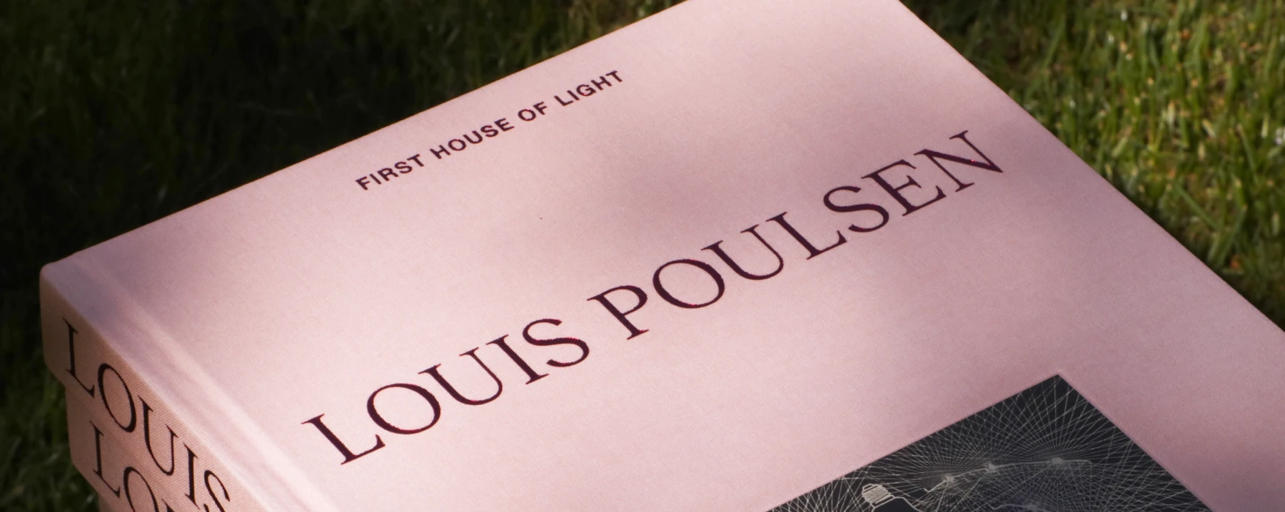 A pink cover reading “First House of Light” and “Louis Poulsen” rests on the grass. © 2026 Louis Poulsen.