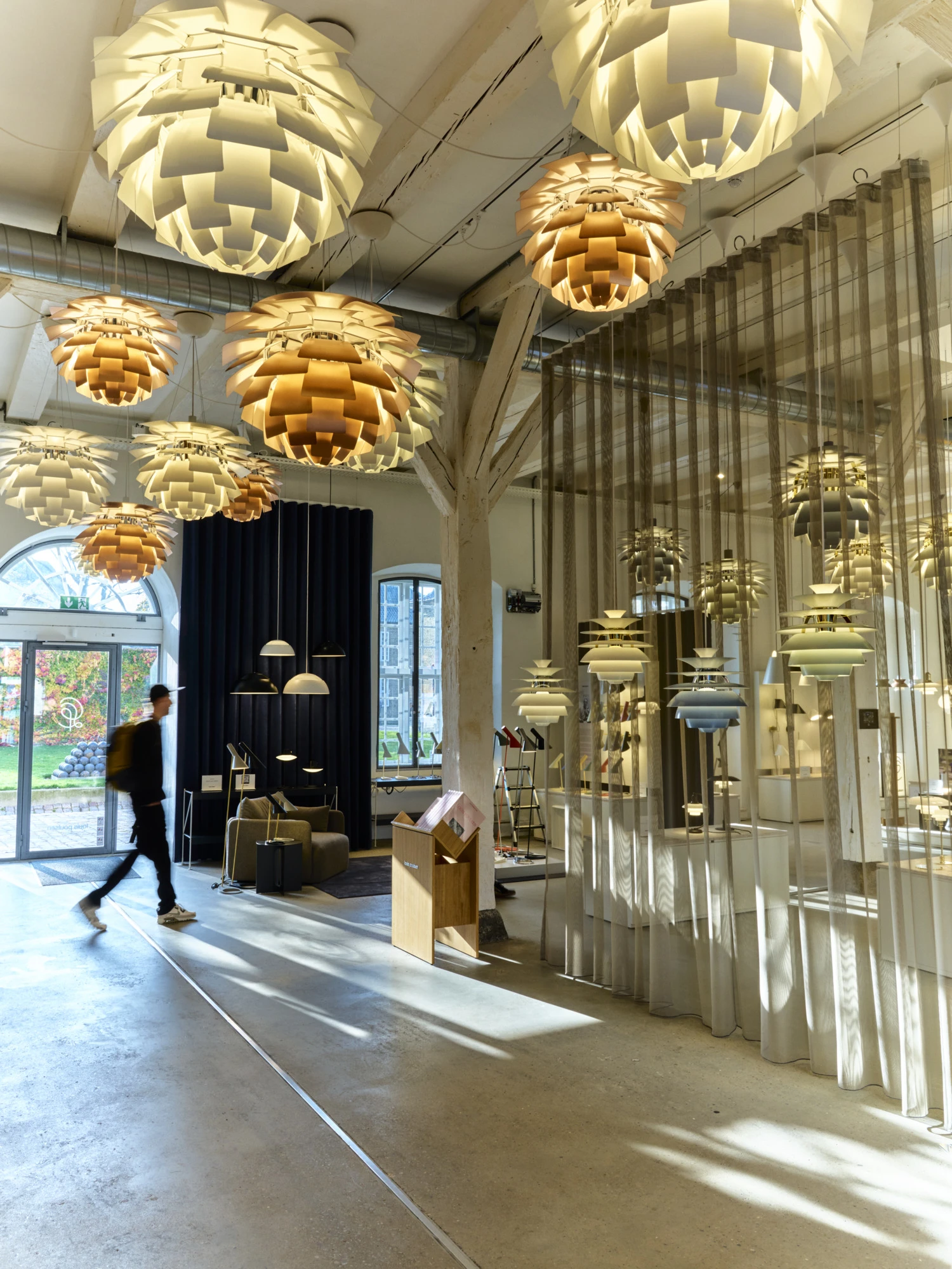 White and copper PH Artichoke pendants illuminate the Louis Poulsen showroom in Copenhagen. © 2026 Louis Poulsen.