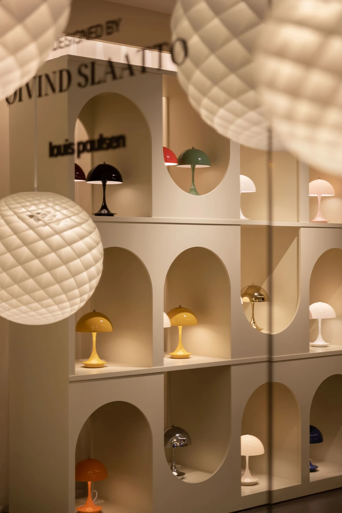 Display of Louis Poulsen table lamps within arched shelving in the Hangzhou Tower store, China, © 2025 Louis Poulsen.
