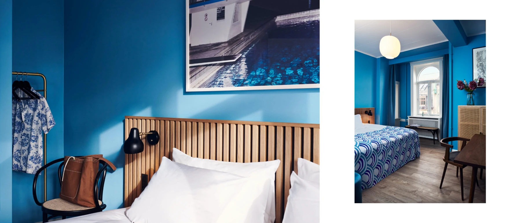 A black AJ Wall Lamp beside the bed and a VL 45 Radiohus Pendant in a blue hotel room. © 2026 Louis Poulsen.