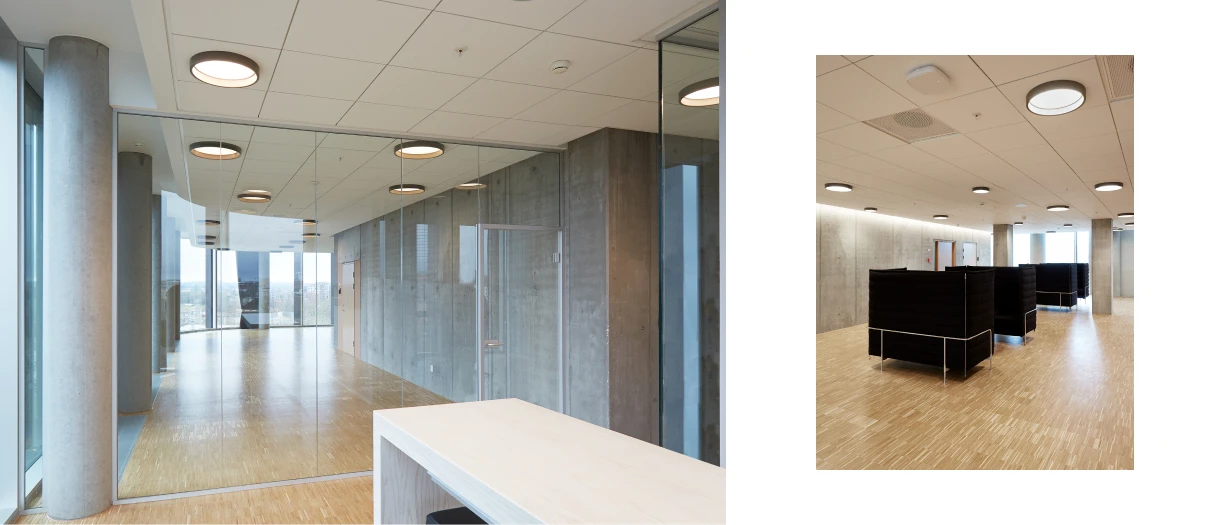LP Circle Recessed inbouwplafondlampen in een moderne gemeenschappelijke kantoorruimte met glazen wanden, beton en een houten vloer. © 2026 Louis Poulsen.