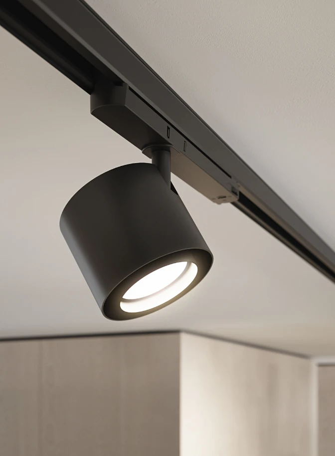 A black LP Xperi spotlight on a track casts light into a bright, minimalist interior. © 2026 Louis Poulsen.