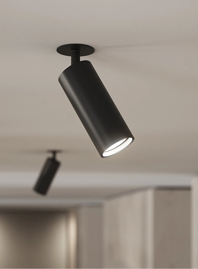 A black LP Xperi ceiling spotlight with an adjustable head in a bright, modern interior. © 2026 Louis Poulsen.