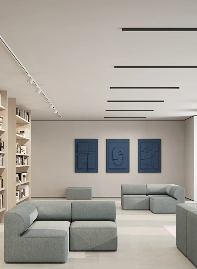 LP 051 Track spotlights and LP Slim Box Recessed in the ceiling of a bright lounge with bookshelves and grey sofas. © 2026 Louis Poulsen.