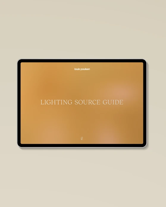 The cover of Louis Poulsen’s Lighting Source Guide appears on a tablet against a warm, neutral background. © 2026 Louis Poulsen.
